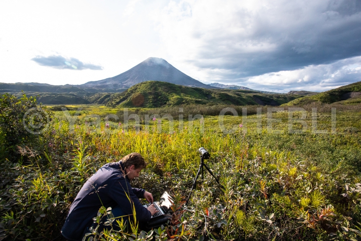 12082019-karymsky-volcano-so2-output-monitoring-kamchatka-08-2019-3729 A volcanologist takes measurements to monitor SO2 gas output from Karymsky volcano plume